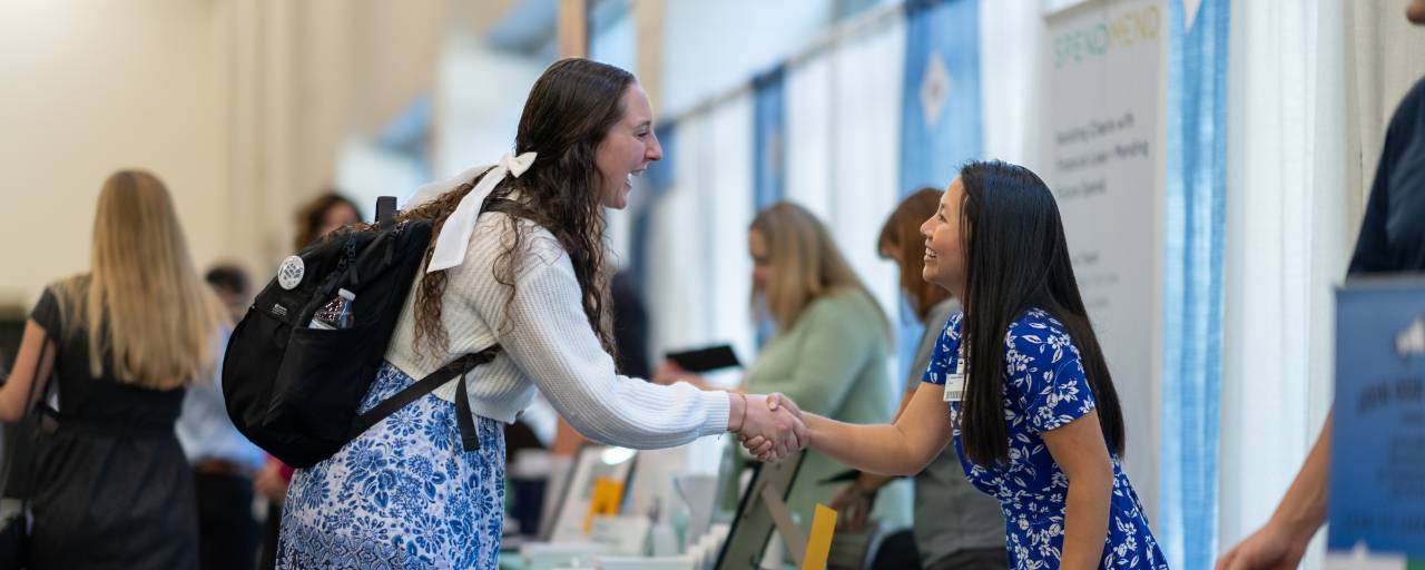 people shaking hands at career fair
